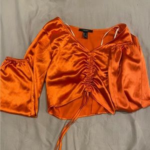 never worn, size small, satin material, elastic wrist sleeves